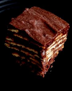 a stack of brownies sitting next to each other on top of a black surface