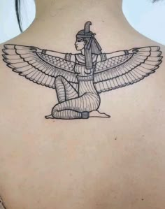 an egyptian tattoo on the back of a woman's neck