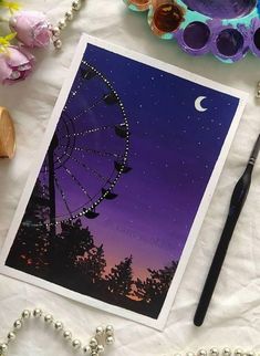 a card with an image of a ferris wheel and the moon in the night sky