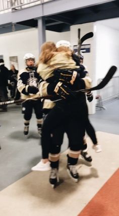 the hockey players are hugging each other on the ice