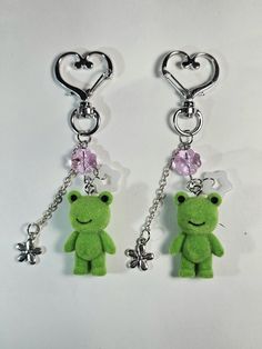 two key chains with green teddy bears attached to them