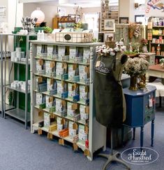 the inside of a flower shop filled with lots of shelves and flowers in vases