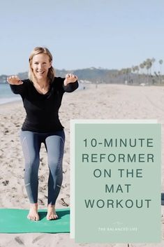 a woman is doing yoga on the beach with her arms in the air and smiling