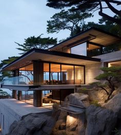 a modern house on top of a rocky cliff