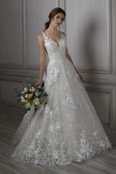 a woman in a white wedding dress holding a bouquet