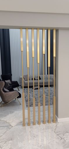 an elegant room with marble floors and gold bars on the wall, in front of a chair