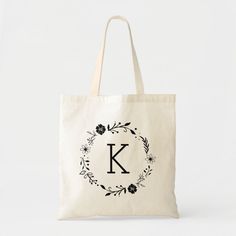 a monogrammed tote bag with the letter k in floral wreath on it