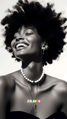 a woman with an afro is laughing and wearing pearls on her necklace, which reads smile