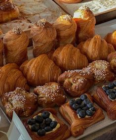 there are many croissants and other pastries on display