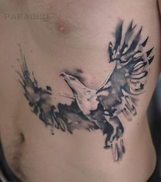 a man's chest with an eagle tattoo on it