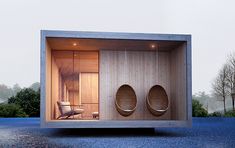 two wooden urinals in the middle of a room