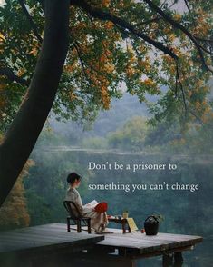 a woman sitting on a bench next to a tree with a quote above her that reads, don't be a prisoner to something you can't change