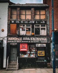 an old brick building with boarded up windows