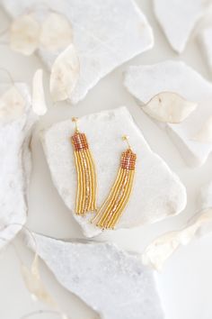 Add a touch of bohemian elegance to your ensemble with these stunning gold and light topaz beaded tassel earrings. Perfect for a boho wedding or any special occasion, these statement seed bead earrings feature a long drop design with studs for added flair. The intricate beadwork and delicate tassel detail will surely make you stand out in style. Elevate your jewelry collection with these eye-catching dangle earrings that effortlessly combine glamour and charm. These earrings are made of the high Bohemian Gold Beaded Drop Earrings, Festive Gold Beaded Dangling Earrings, Gold Copper Drop Beaded Earrings, 14k Gold-filled Beaded Dangle Earrings, Wedding Dangle Earrings, Bohemian 14k Gold-filled Beaded Dangle Earrings, Boho Wedding Jewelry, Beaded Tassel Earrings, Drop Design