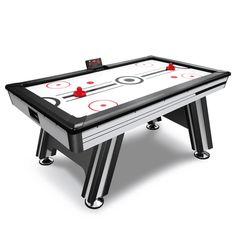 an air hockey table with red and black balls on the top, in front of a white background