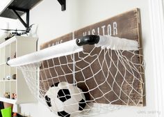 a soccer ball in a net hanging on a wall