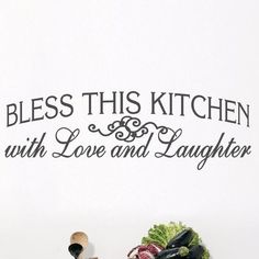 there is a wall decal that says, i love and laughter with vegetables in the foreground