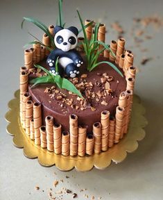 a cake decorated with bamboo sticks and a panda figurine