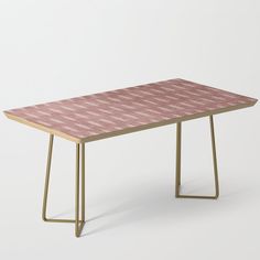 a pink and white checkered table with gold legs