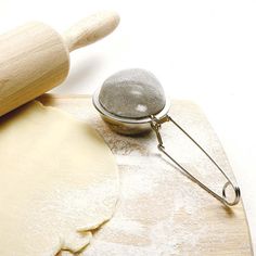 a rolling pin and dough on a cutting board