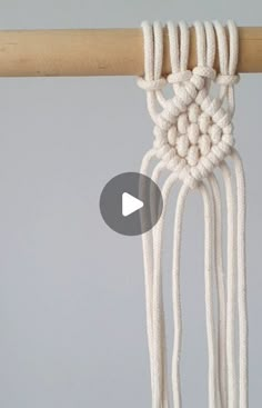 the video shows how to make a macrame wall hanging with yarn and cotton