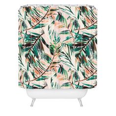 a shower curtain with tropical leaves on it