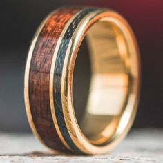 a wooden ring with gold and black inlays