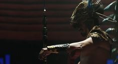 a man dressed up like an egyptian warrior with his arm outstretched and headdress on