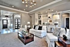 a living room filled with furniture and a chandelier