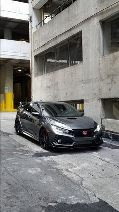 a black car parked in front of a building