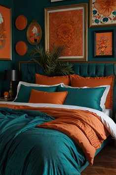 an orange and teal bedroom with pictures on the wall, bedding and pillows