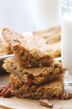 three cookies stacked on top of each other next to a glass of milk