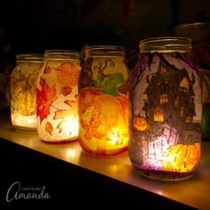 some jars with candles in them sitting on a shelf