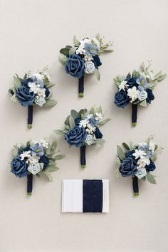 wedding bouquets and boutonnieres laid out on a table