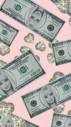 many dollar bills with glitter hearts on pink background, all over the place in front of them