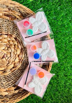 four soaps sitting on top of a basket in the grass