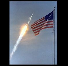 an american flag flying in the air with a rocket coming from it's back