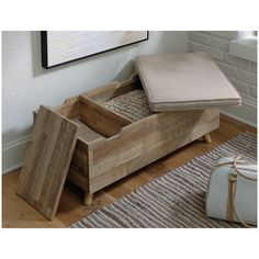 a wooden bench sitting on top of a hard wood floor next to a white purse