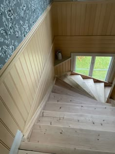 the stairs are made of wood and have been painted blue with white flowers on them