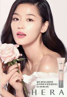 an advertisement for hera cosmetics with a woman holding a rose in front of her face