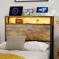 a bed with a wooden headboard and two clocks on top of the head board