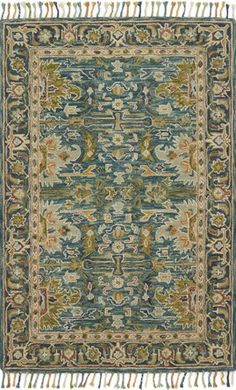 a blue rug with fringes on the bottom and an ornate design in the middle