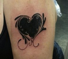 a black heart tattoo on the left arm