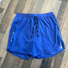 Never Been Worn- Standard Fit 7” Length Shorts Nike Running Bottoms With Pockets, Blue Running Bottoms For Summer, Nike Stretch Blue Bottoms, Blue Athletic Shorts With Pockets For Running, Blue Sports Bottoms With Pockets, Nike Stretch Athletic Shorts With Pockets, Blue Athletic Shorts With Pockets For Gym, Blue Activewear With Pockets And Short Legs, Casual Blue Running Pants