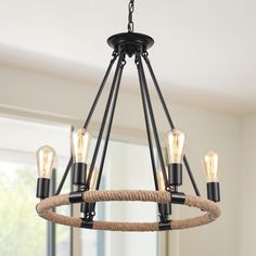 a chandelier with rope and lights hanging from it