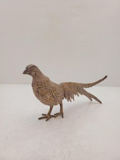 a statue of a bird standing on its hind legs