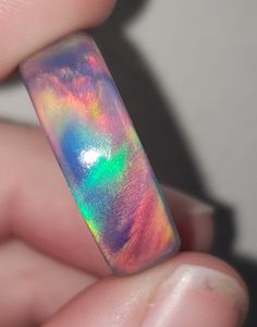 OPAREX synthetic opal is more durable and cost effective than your average opal, ensuring you will have your ring for years to come! The color shifts depending on the angle it is viewed, creating a rainbow of colors. The material is semi transparent, giving it an almost glowing effect. It is inspired by Dragon's Fire, displaying all the colors of a flame at it's hottest point. 8 mm wide This synthetic opal ring comes in a size 8 1/2 and was turned on a lathe. It is then sanded from 60 grit all t Iridescent Opal Ring As Gift, Unique Handmade Iridescent Opal Ring, Iridescent Opal Ring For Gift, Multicolor Opal Round Ring, Iridescent Opal Ring As A Gift, Multicolor Opal Ring Gift, Iridescent Opal Ring Gift, Iridescent Opal Ring Perfect For Gifts, Iridescent Opal Ring With Unique Style