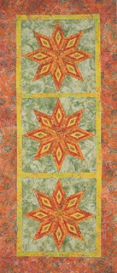 an orange, green and yellow quilt with three squares