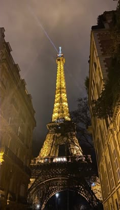 the eiffel tower is lit up at night