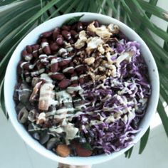 a white bowl filled with red cabbage and nuts